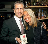 Tom Toumazis celebrating his MBE with wife Helen