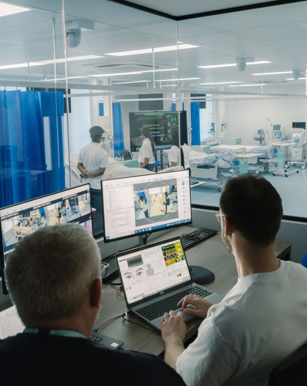 Lectures watch students working in the clinical skills simulation ward from the observation room.